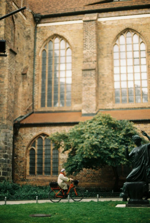 a statue with a bicycle next to it in a courtyard