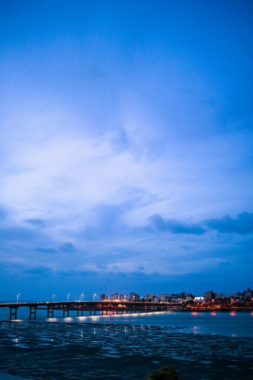 a long bridge stretching over the ocean towards an island