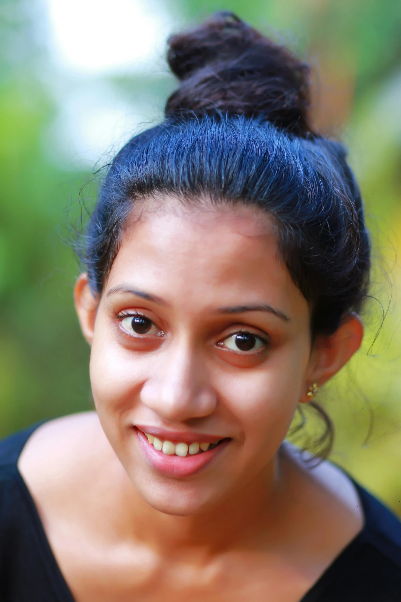 a woman with blue hair smiling and looking at the camera