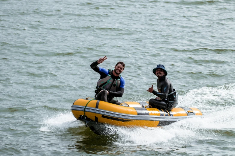 two men are riding on a raft in the water