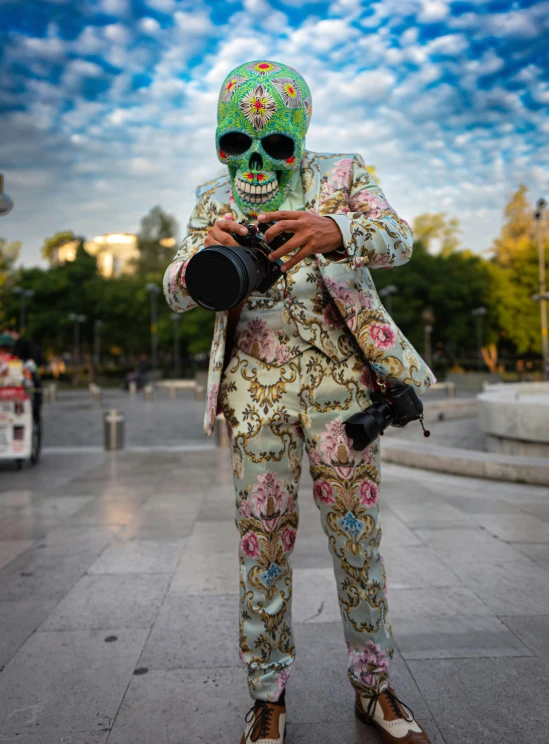 a skeleton dressed in colorful clothes takes pictures