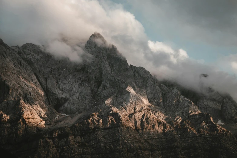 there is a mountain with clouds on it