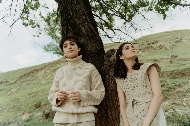 two women are looking up at the tree