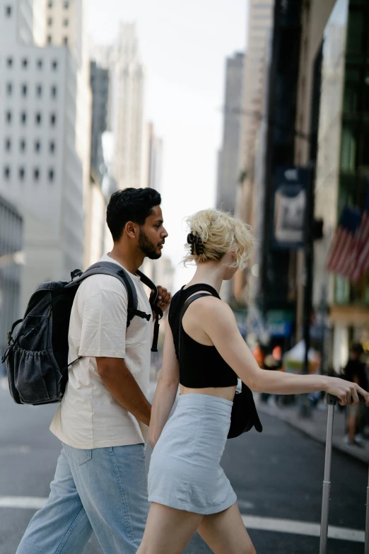 a couple of people walking across the street