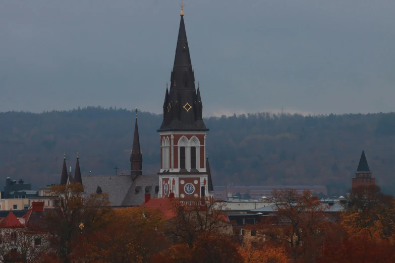 a clock tower with an overcast sky in the background