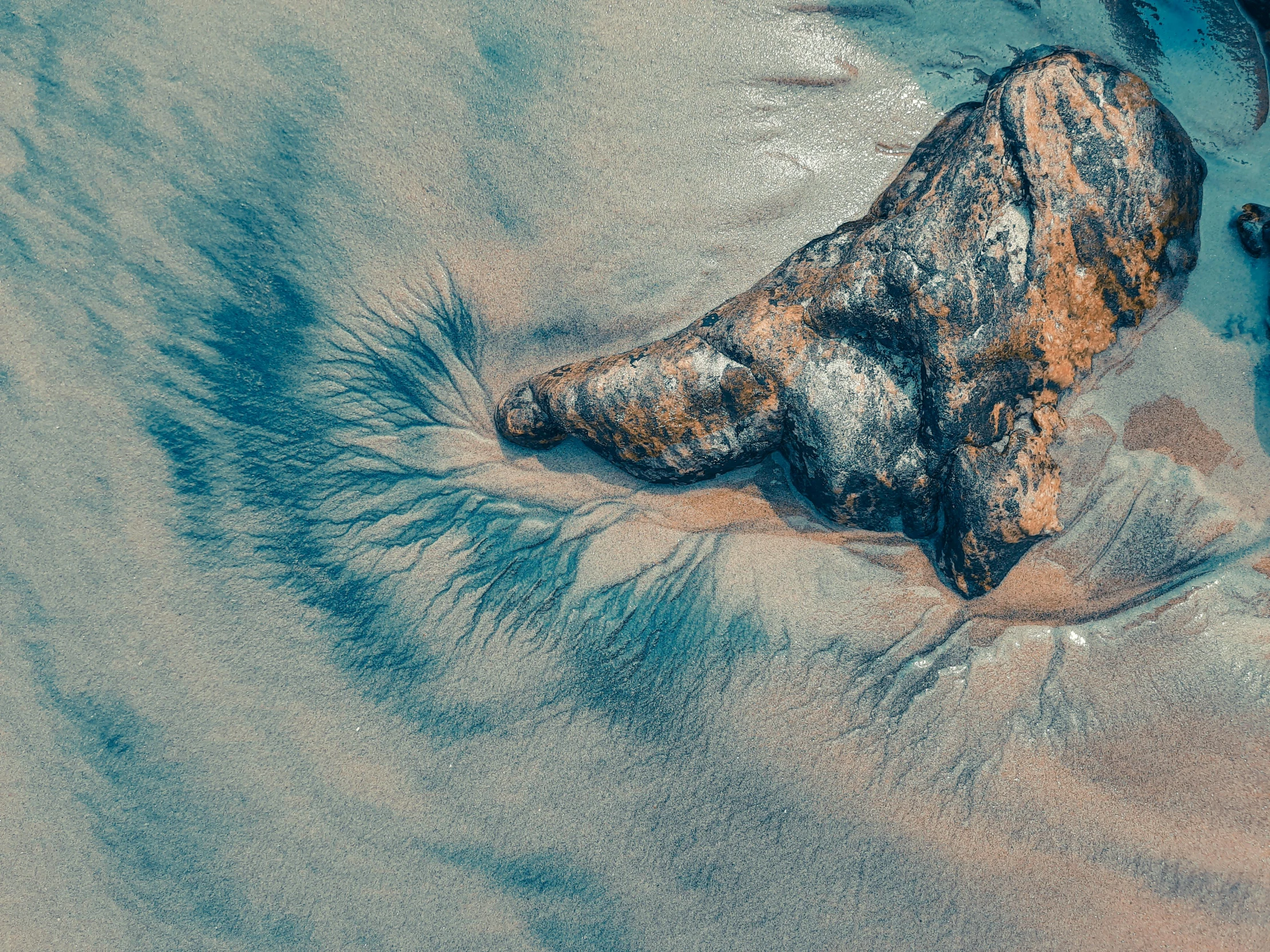 sand and water are seen in this aerial po