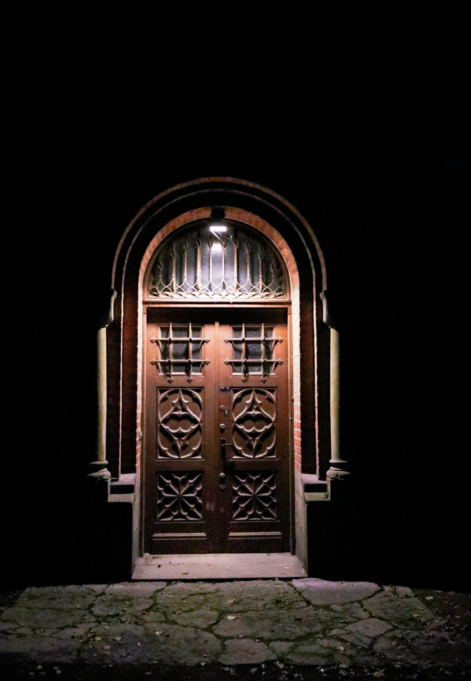 a dark doorway is lit by the lighting from the outside