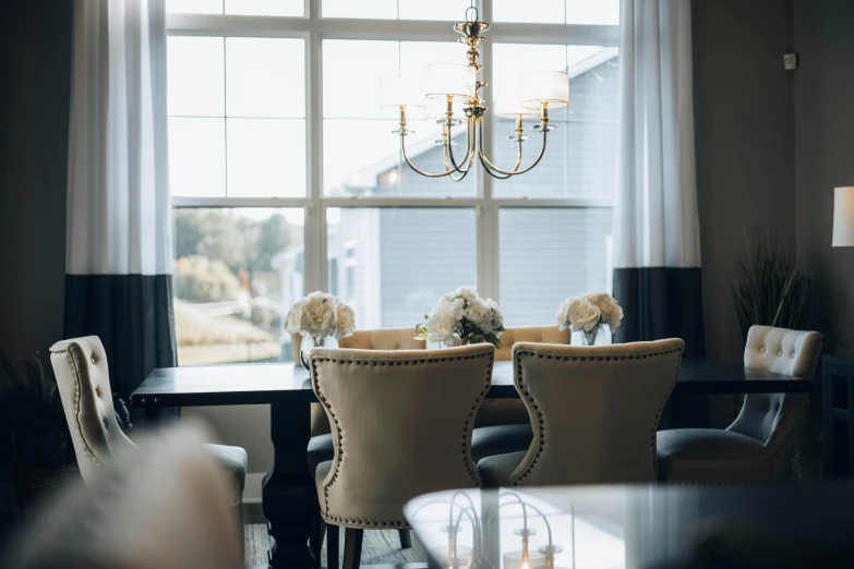 a dining room table with chairs and a glass vase