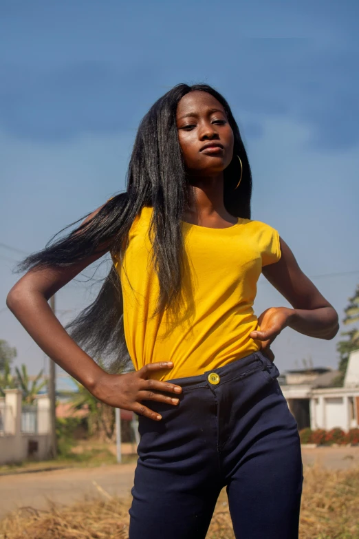 a young woman is holding her hair straight