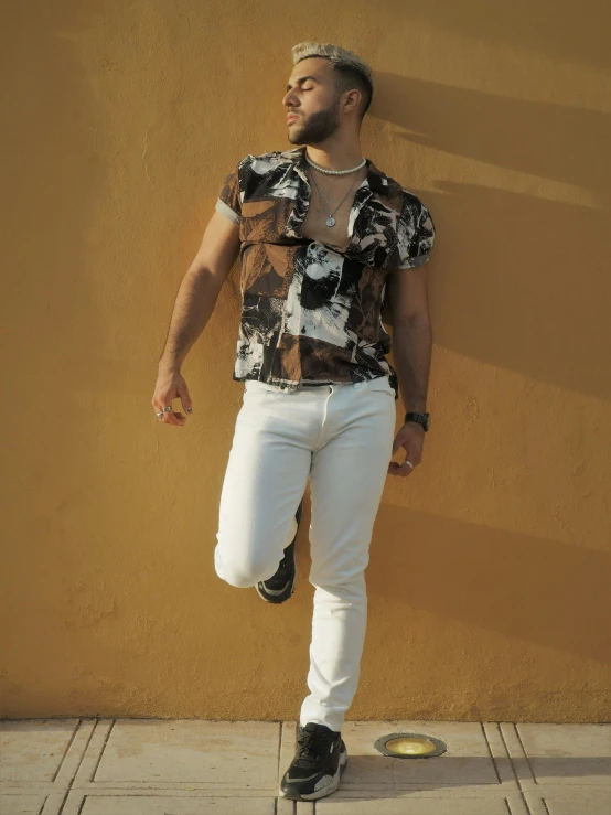 man standing in front of a tan colored wall