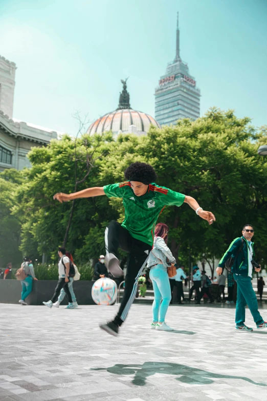 s playing soccer outside in the city, one kicking the ball