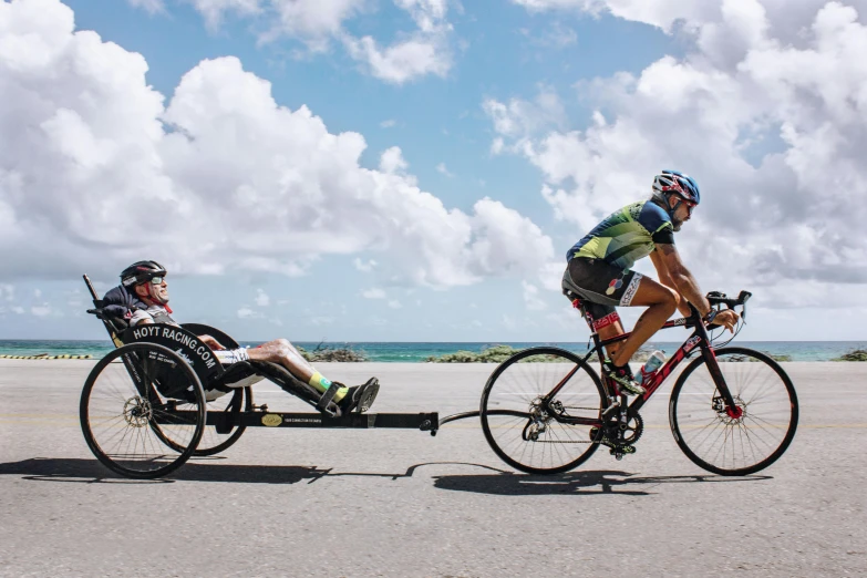 two men are riding bikes next to each other