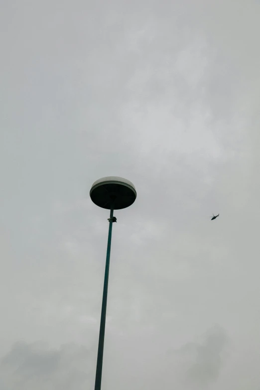 an airplane flying over a large metal pole