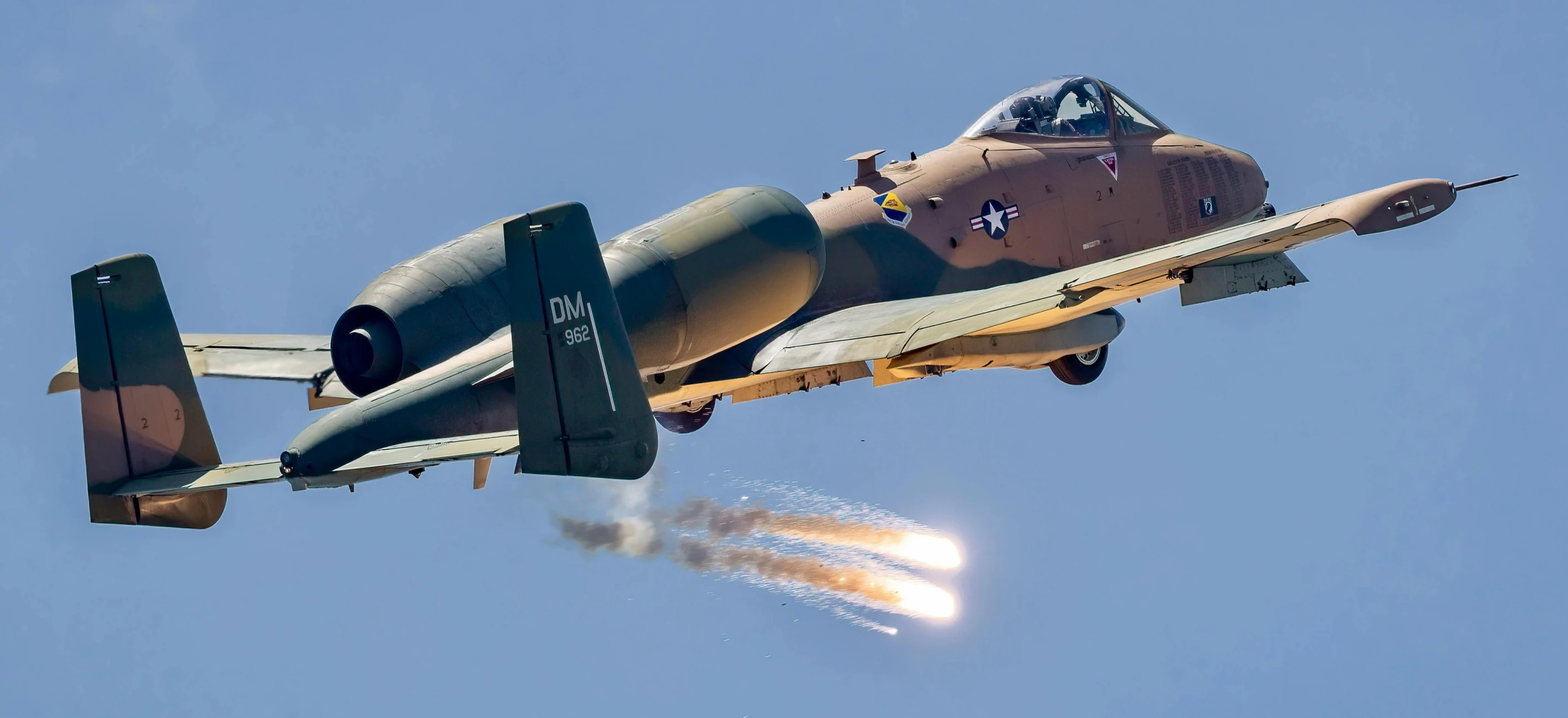 a small aircraft flying through a blue sky