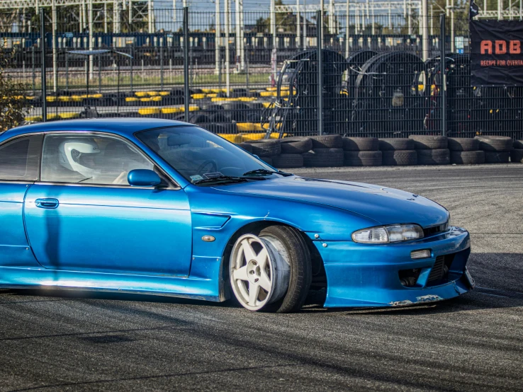 a blue car parked on top of an asphalt track