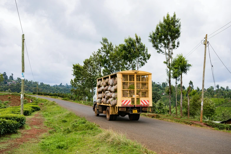 a truck that is going down a dirt road