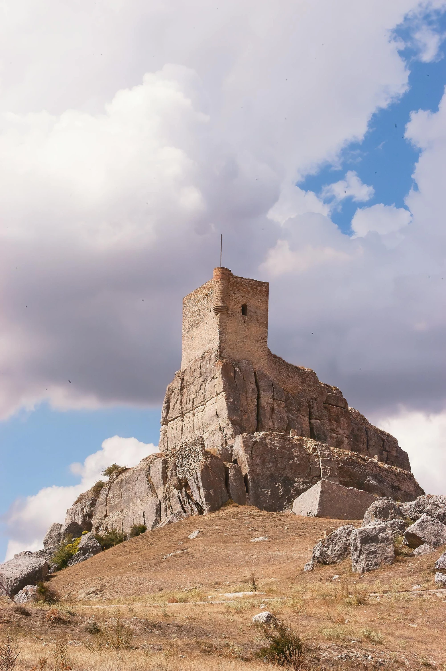 a tall castle on top of a mountain