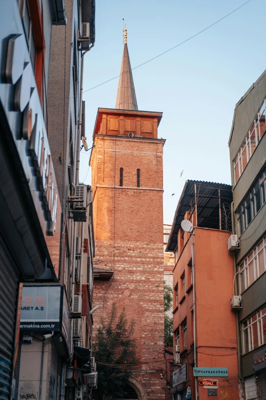 a tall tower with a clock on top in a city