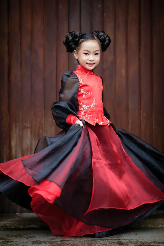 a girl dressed in red and black wearing a chinese dress