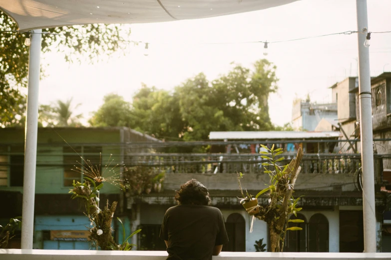 a man sitting on a bench watching a man doing soing