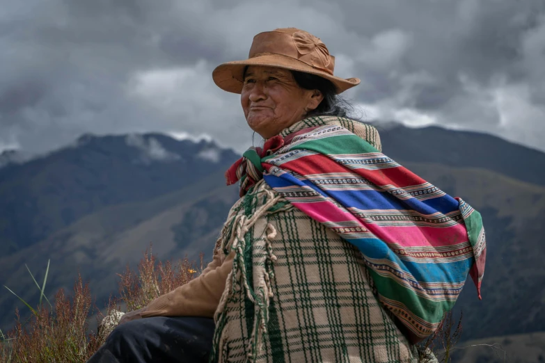 a man in a hat, blanket and brown jacket