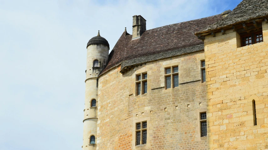 two windows are located on the roof of this old building