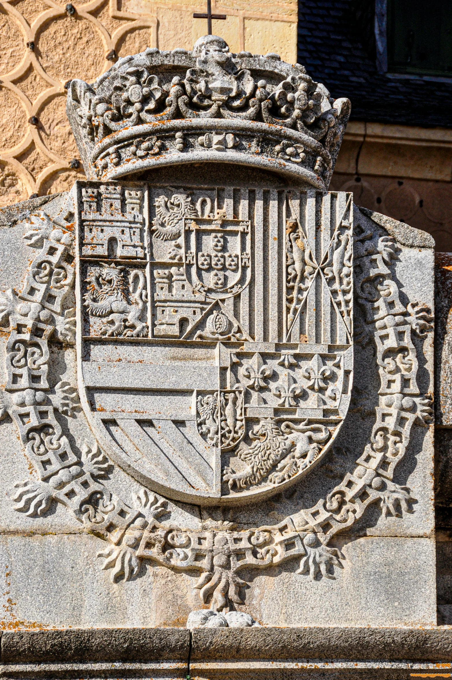 a cement sign has an intricate design on it