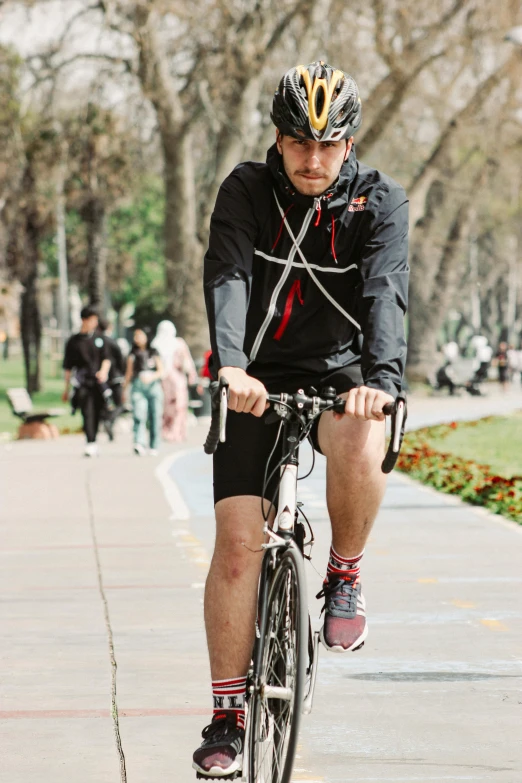 a man in black is riding a bike