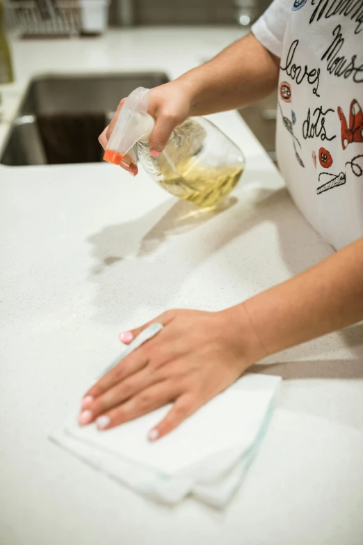 a woman pours a lot of alcohol onto some material