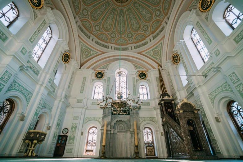 a beautiful white church with some gold ornaments on the ceiling