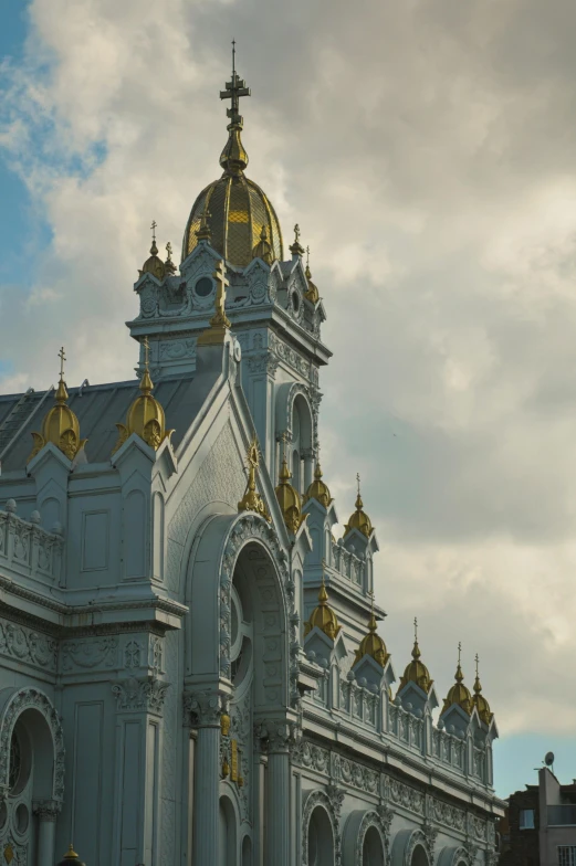 the golden steeple of a church against a blue sky