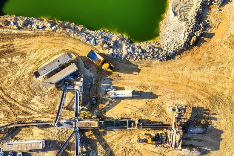 a large machine in an open area next to some water