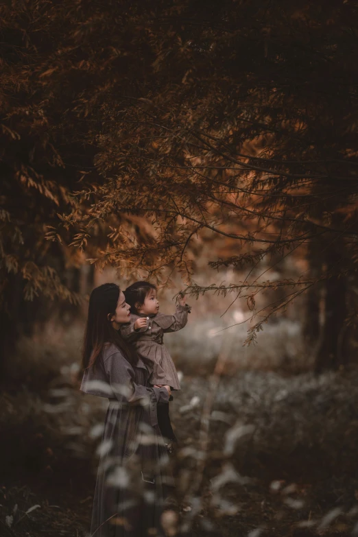 a  hugging her boyfriend outside under a tree