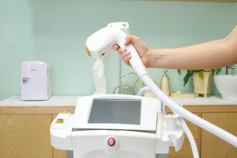 a person uses a device to cool a skin