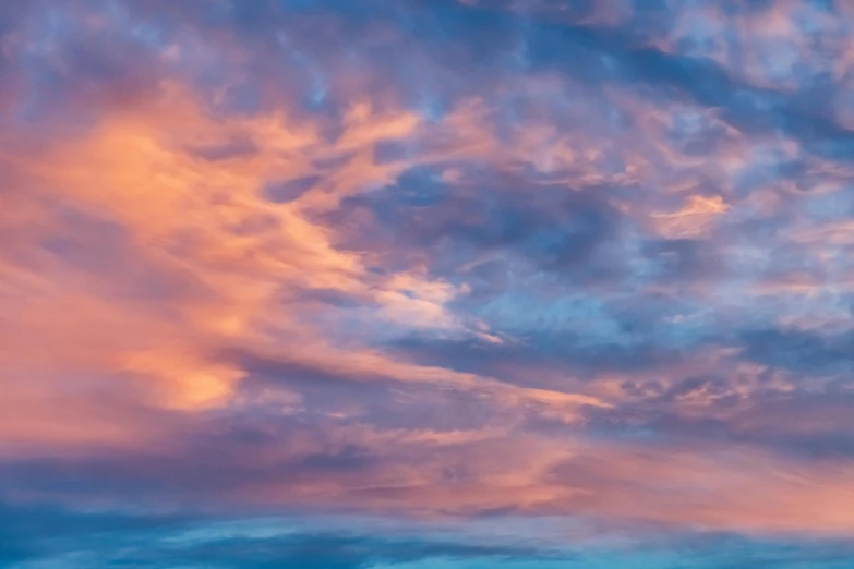 the blue and pink clouds in the sky