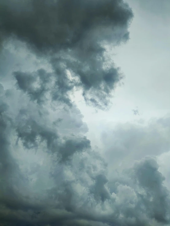 an airplane flying through clouds in the sky