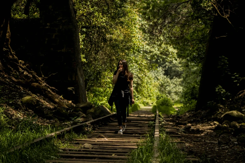 a person walking down some tracks in the forest