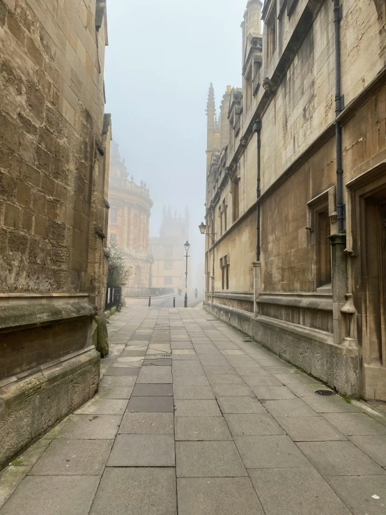 a walkway between buildings on the side of a road