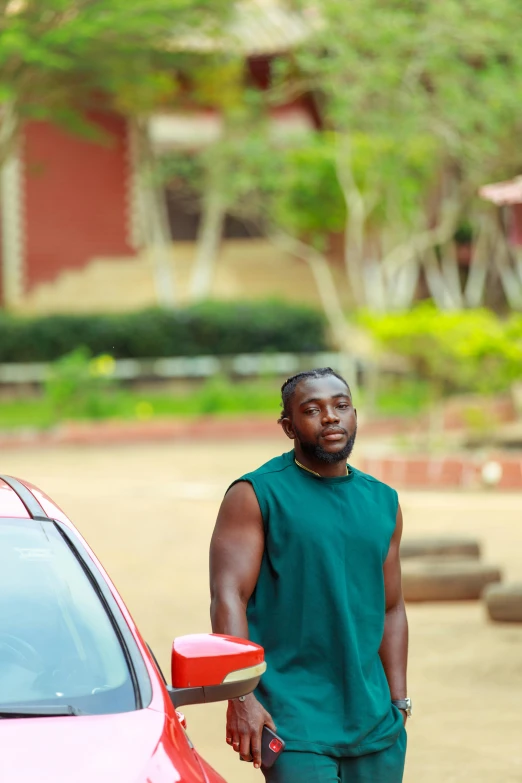 a man is leaning on the hood of a car