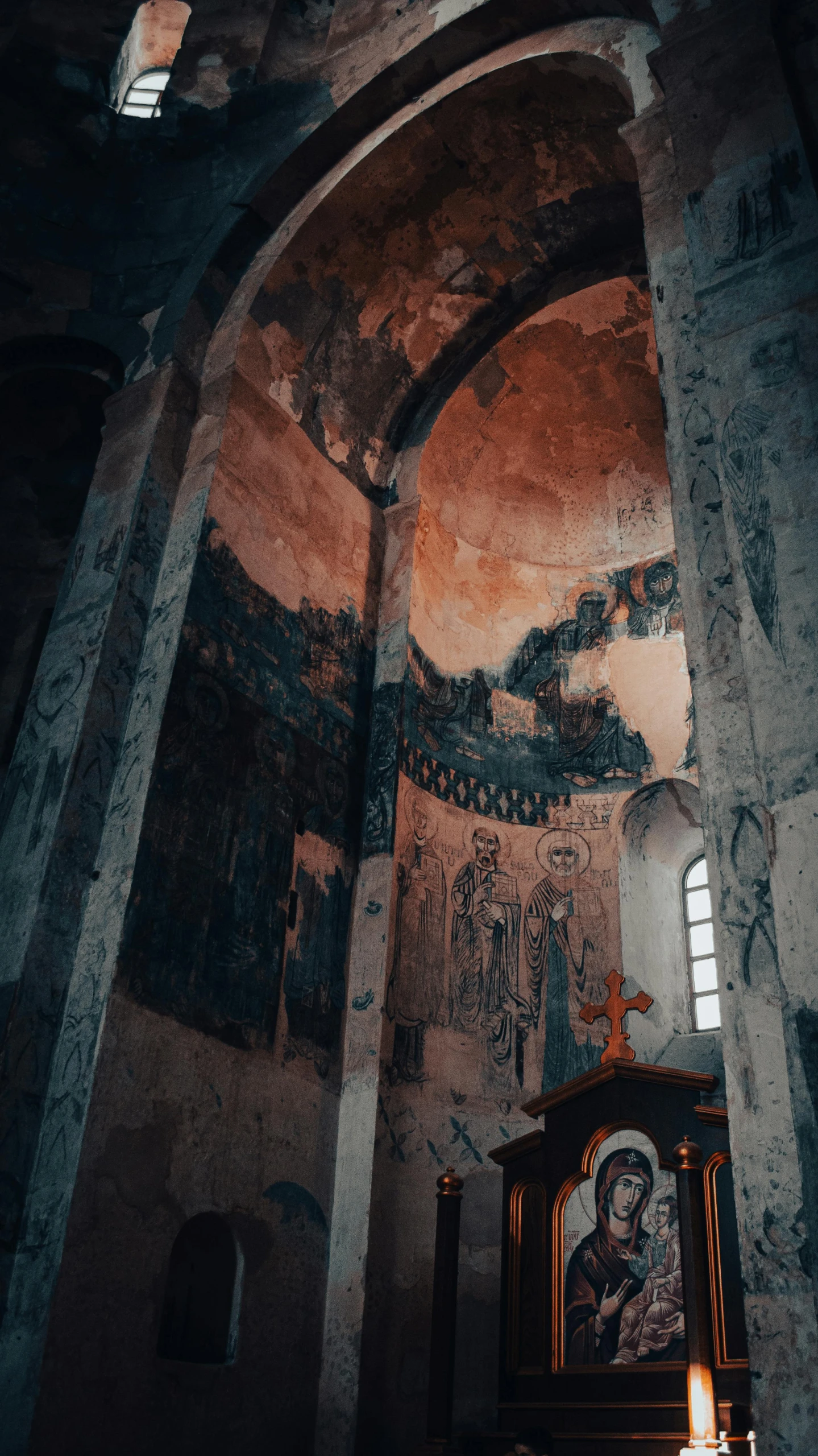 some paintings are shown above a shrine