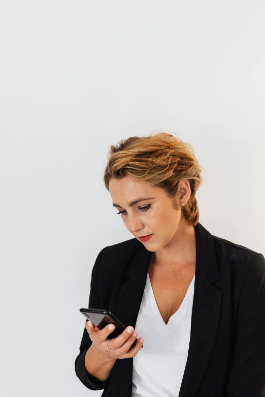 a woman looks down as she checks her cell phone