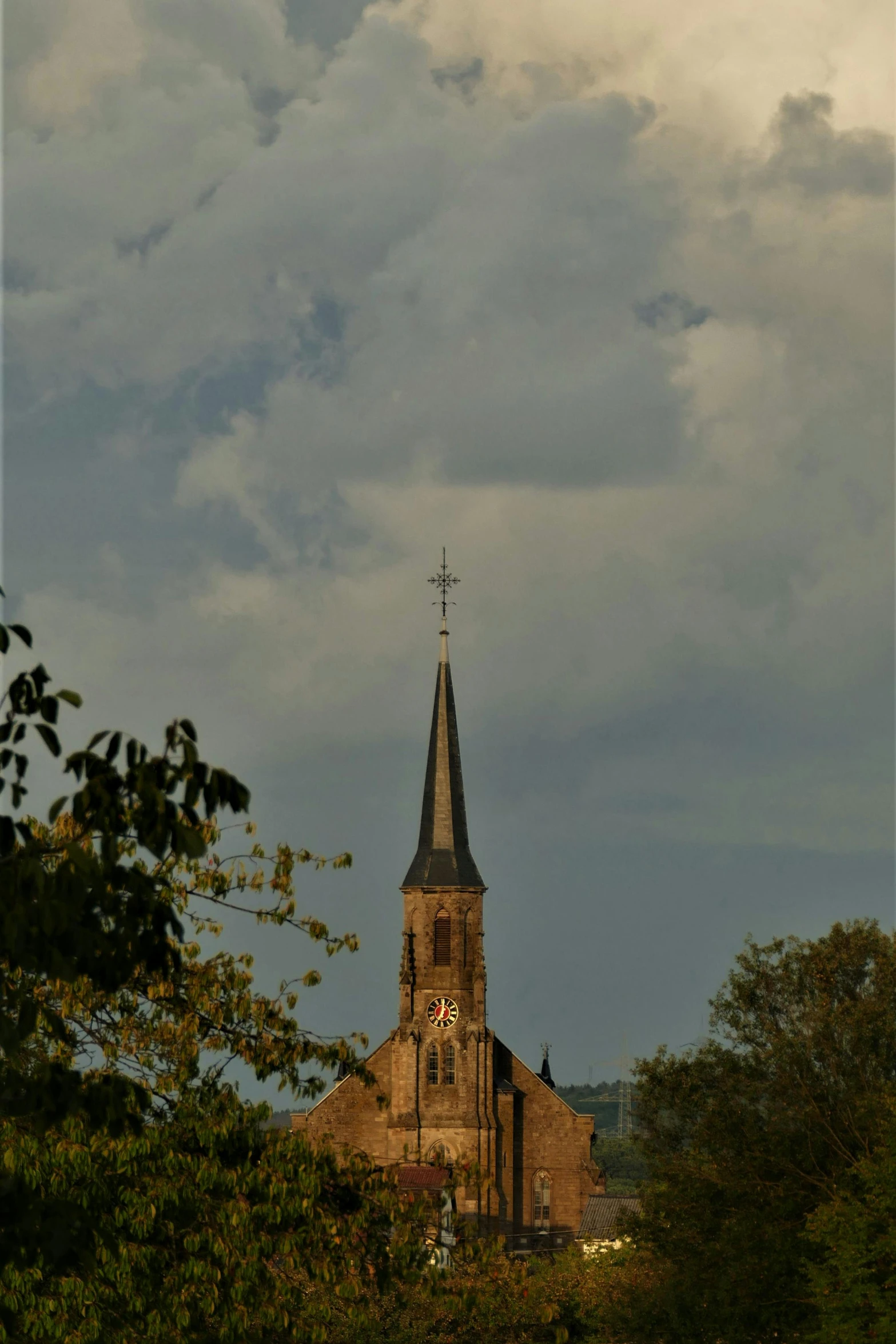 a brown steeple with a small tower on the top