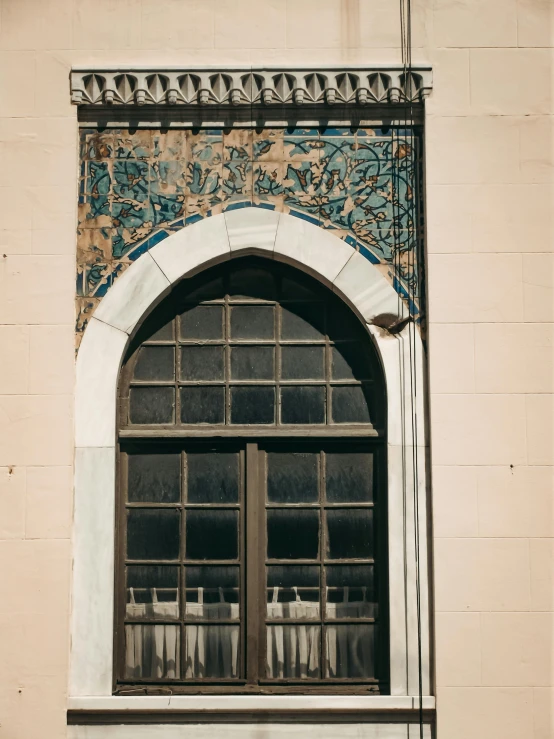 a window with windows and decorative designs above it