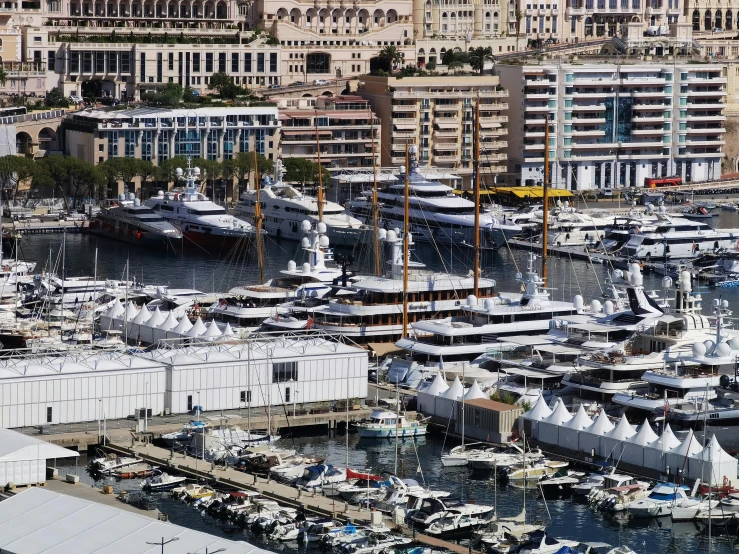 many large boats parked at a dock in a large marina