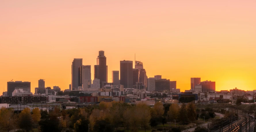 an orange sky at sunset over a city