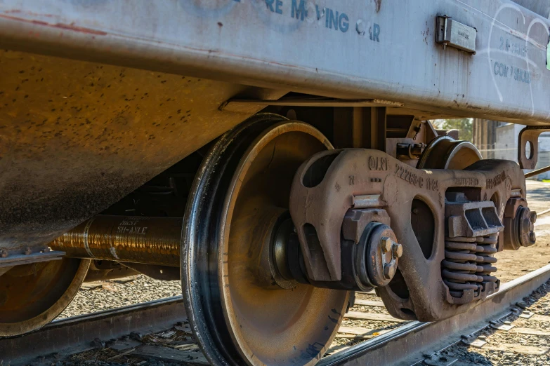 an antique train wheel is close up with a worn and rusted face