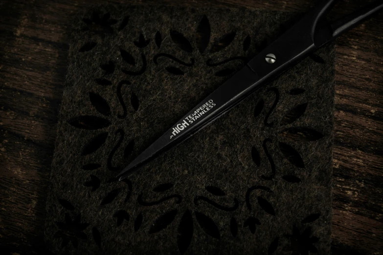 there is a black scissors with a logo on it