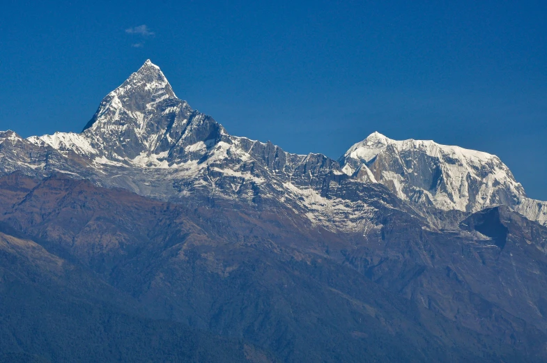 two people walking towards the base of a mountain