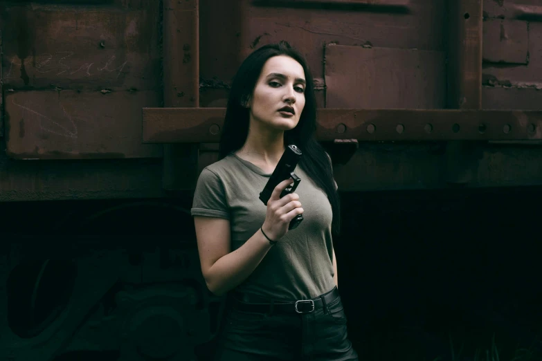 the woman is posing in front of a train car