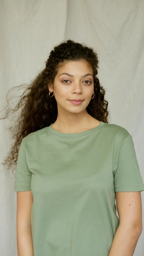 a woman posing for the camera with her hair blowing in the wind